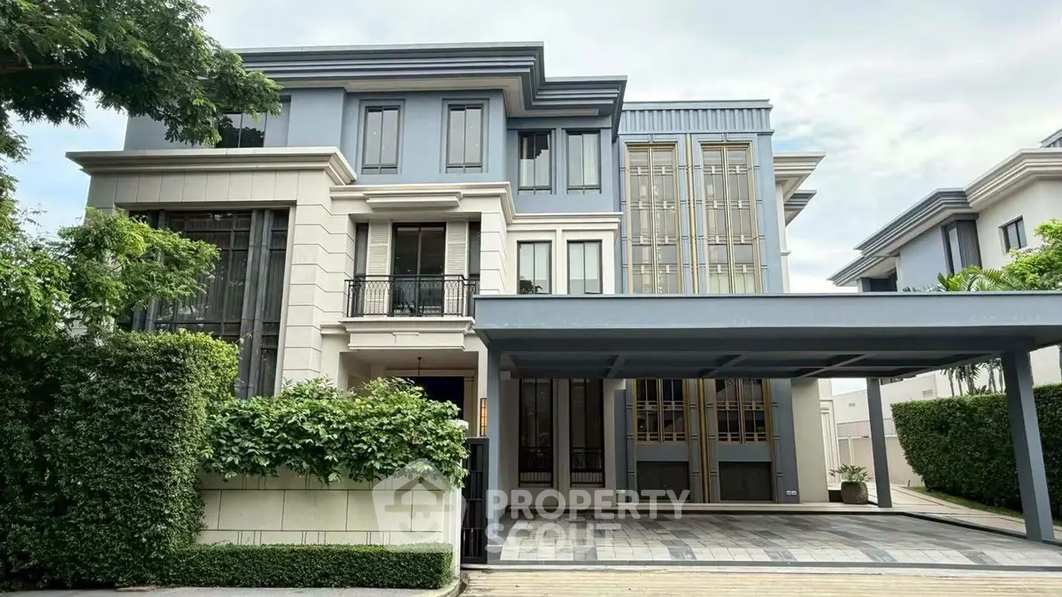 Luxurious modern three-story house with elegant facade and spacious driveway in a serene neighborhood.