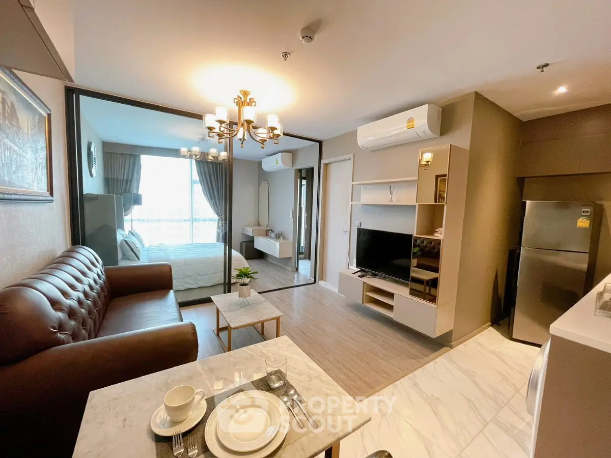 Modern apartment interior with open living room and kitchen, featuring elegant decor and natural light.