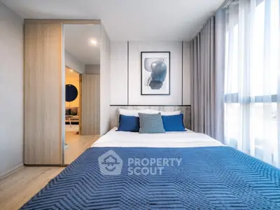 Modern bedroom with stylish decor and large window for natural light