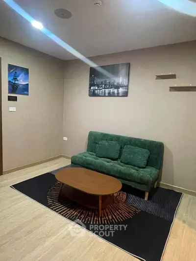 Cozy living room with green sofa and modern decor in stylish apartment.
