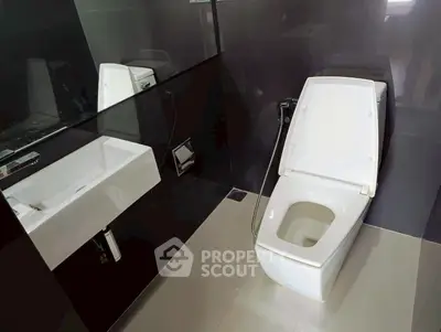 Modern bathroom with sleek black tiles and contemporary fixtures