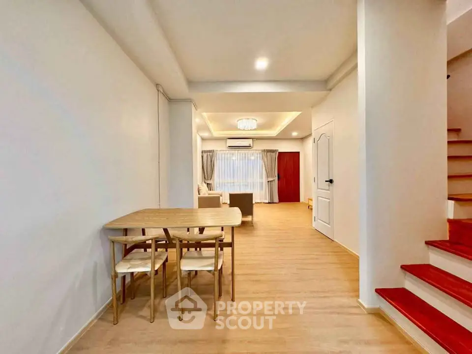 Spacious open-plan living and dining area with modern decor and natural light.