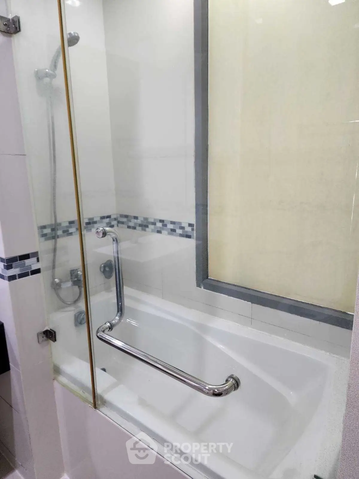 Modern bathroom with sleek bathtub and glass shower enclosure