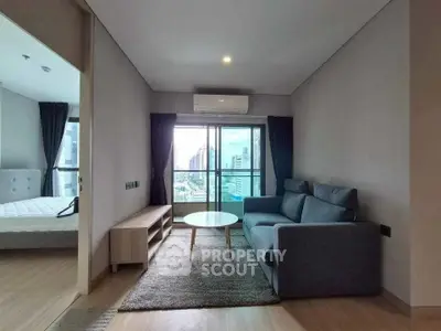 Modern living room with city view, featuring a cozy sofa and sleek design.