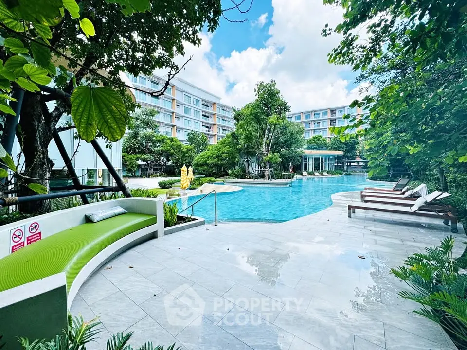 Luxurious outdoor pool area with lush greenery and modern seating, perfect for relaxation and leisure.