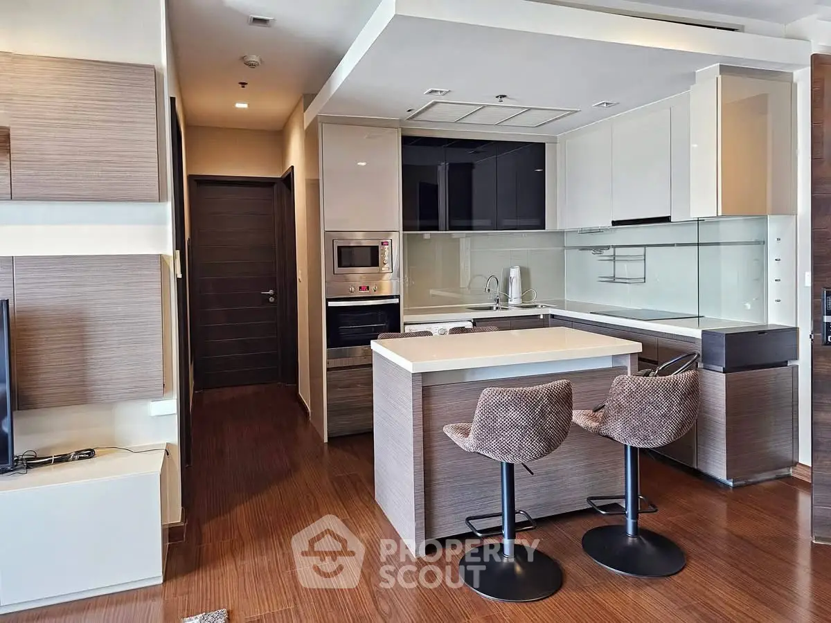 Modern kitchen with island and stylish bar stools in a contemporary apartment