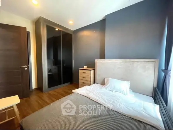 Modern bedroom with stylish decor and ample natural light