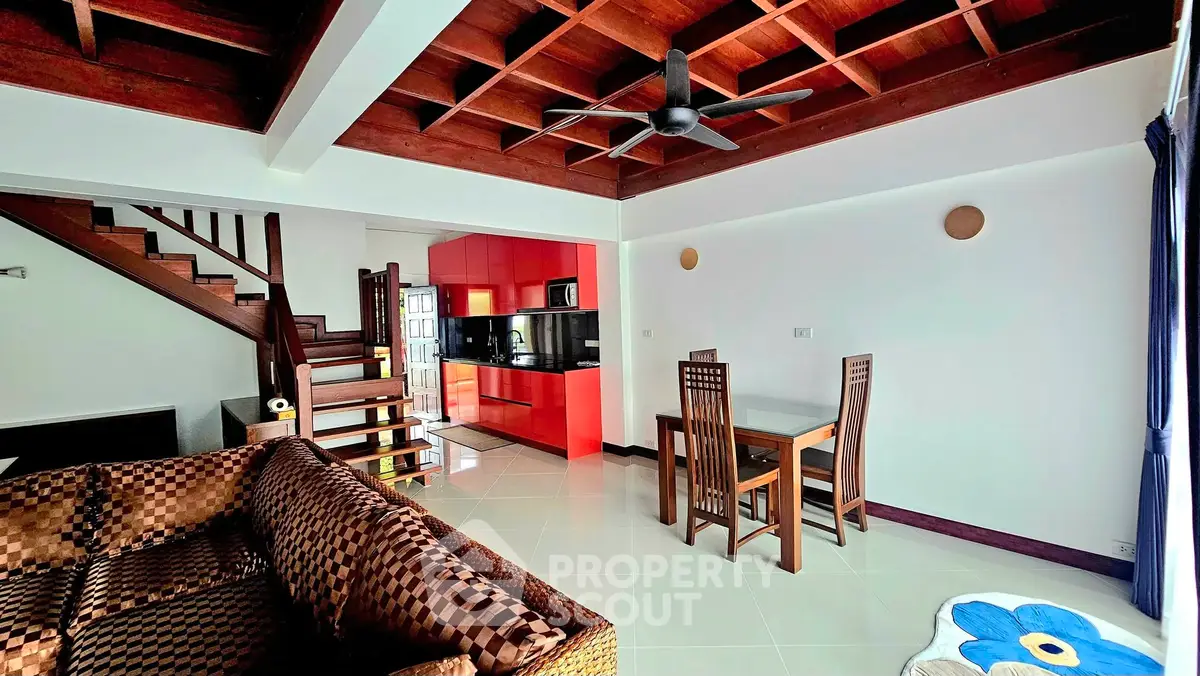 Stylish living room with wooden ceiling and modern kitchen in open layout