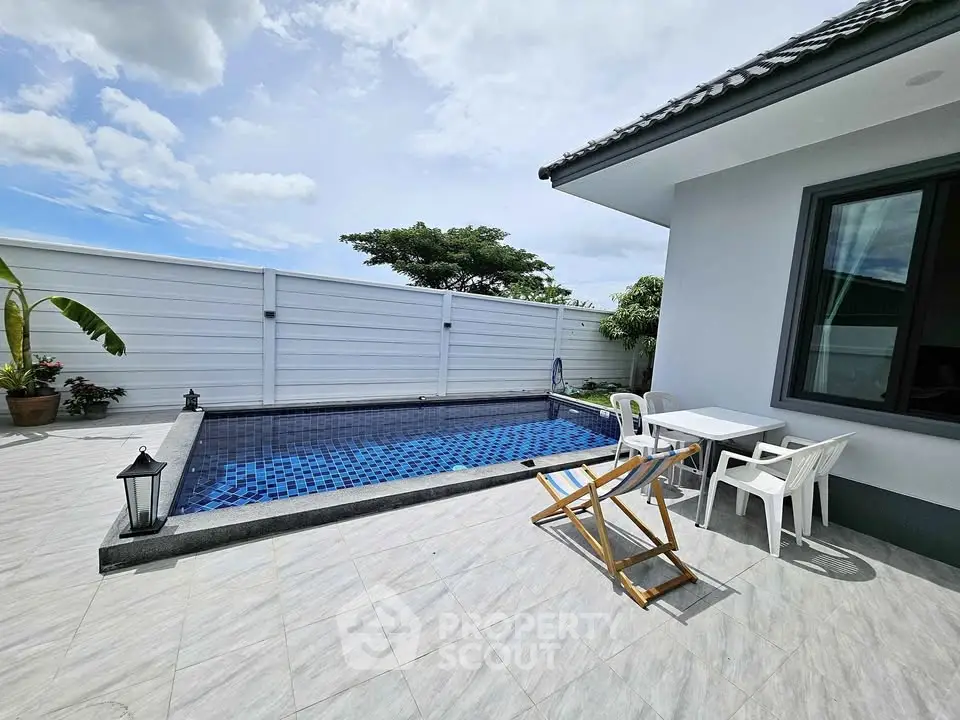 Charming outdoor pool area with modern patio furniture and serene ambiance.