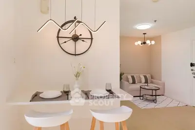 Modern open-plan living room with stylish lighting and cozy seating area.