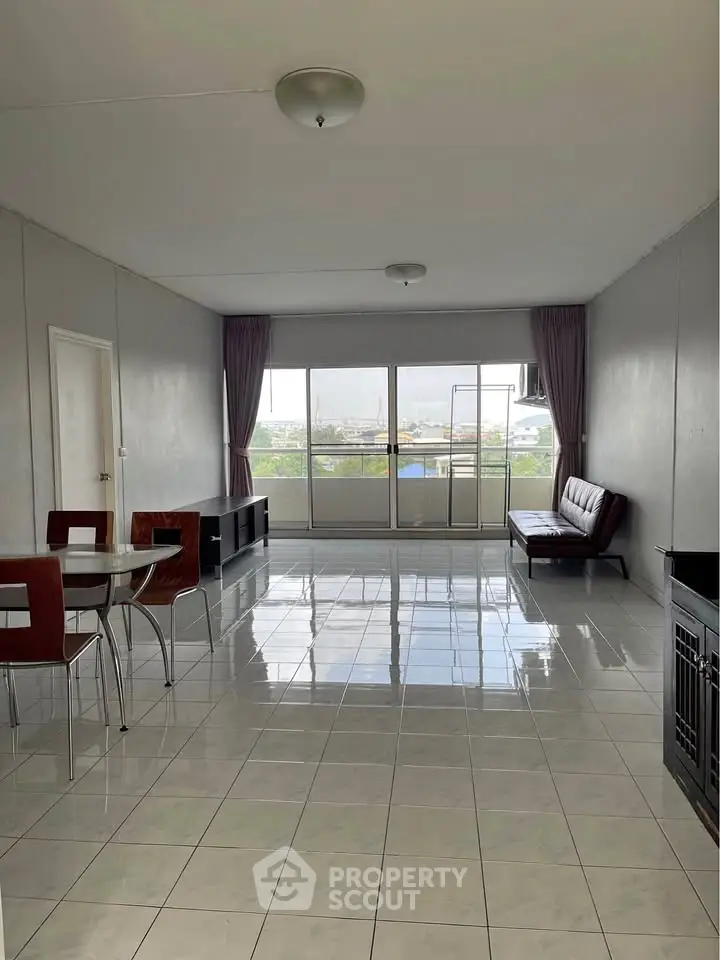 Spacious living room with modern furniture and large windows offering natural light.