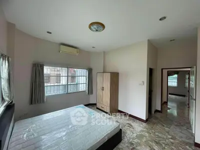 Spacious bedroom with large windows and modern wardrobe in a bright apartment