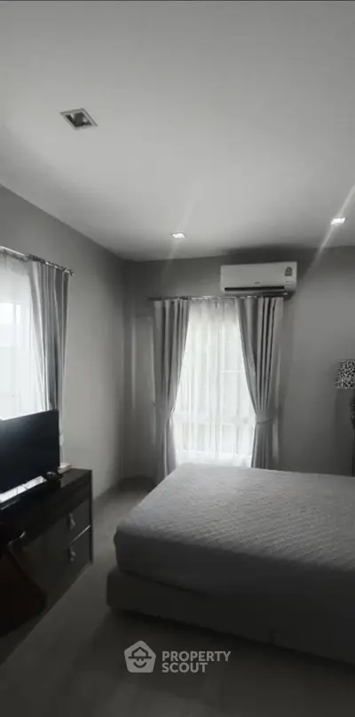 Modern bedroom with air conditioning and natural light