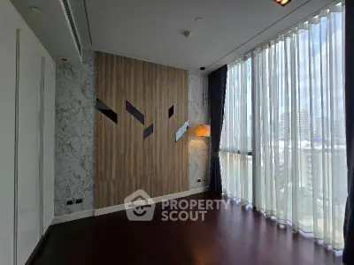 Spacious modern living room with floor-to-ceiling windows and elegant wood paneling.