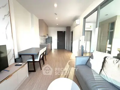 Modern living room with stylish furniture and open layout, featuring natural light and contemporary design.
