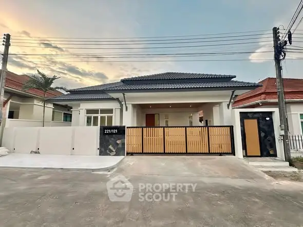 Charming single-story house with modern design and spacious driveway in a serene neighborhood.