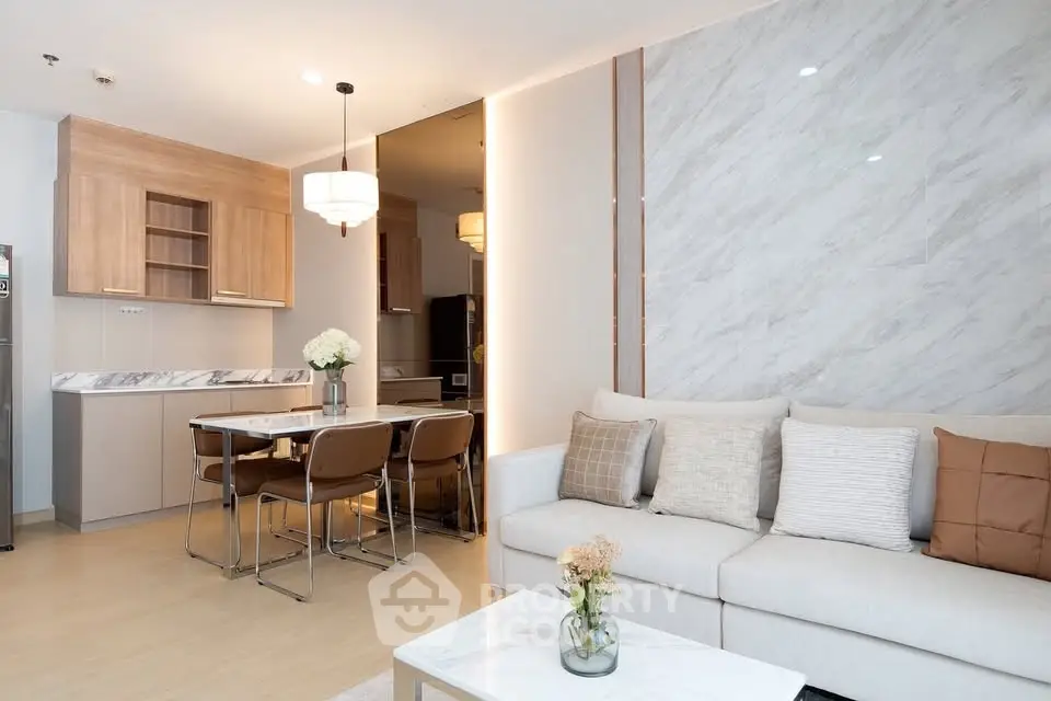 Modern open-layout living room with stylish kitchen and elegant decor