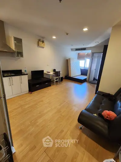 Spacious open-layout living room with modern kitchen and cozy seating area