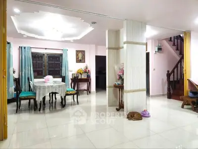 Spacious living room with elegant dining area and polished tile flooring