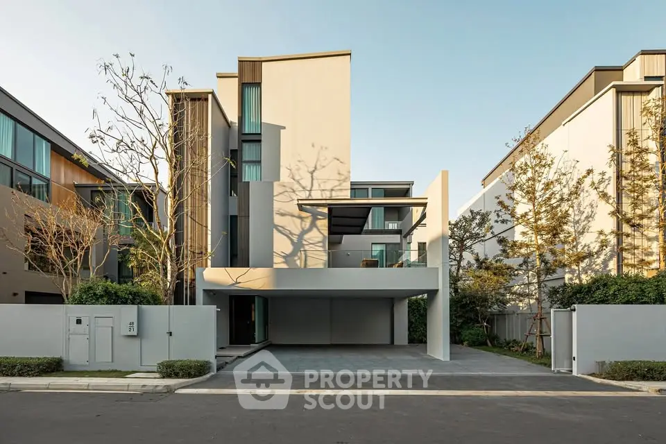 Modern luxury townhouse with sleek design and spacious driveway in a serene neighborhood.