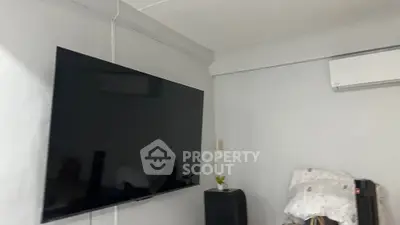 Modern living room with wall-mounted TV and air conditioning unit