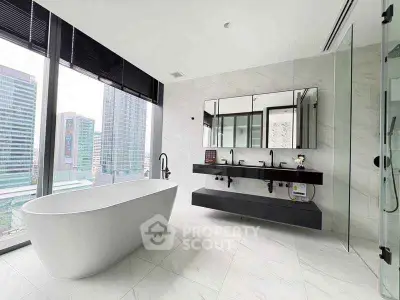 Luxurious modern bathroom with freestanding tub and city view
