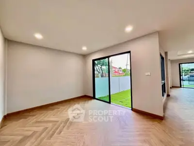 Spacious modern living room with large windows and garden view