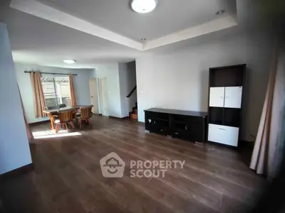 Spacious living room with modern furnishings and natural light, perfect for family gatherings.