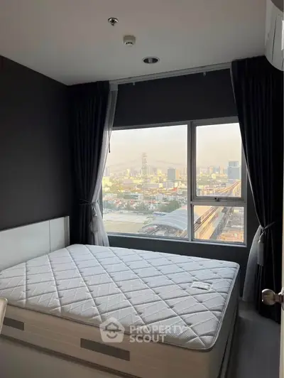 Modern bedroom with large window offering stunning city view, featuring a comfortable bed and elegant dark curtains.