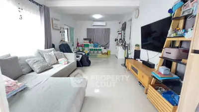 Spacious living room with modern decor and ample natural light