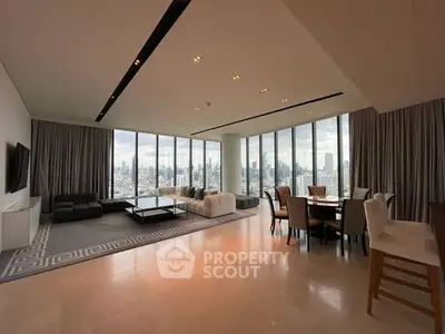 Luxurious open-plan living room with panoramic city views and elegant furnishings.