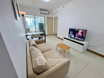 Spacious living room with modern decor and natural light in a cozy apartment.