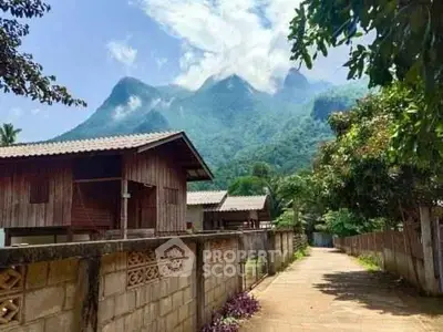 Charming rustic wooden houses with stunning mountain backdrop, perfect for serene living or vacation retreat.