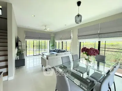 Spacious modern living room with elegant dining area and garden view