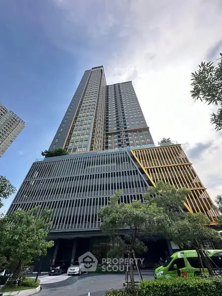 Stunning modern high-rise building with unique architectural design and lush greenery