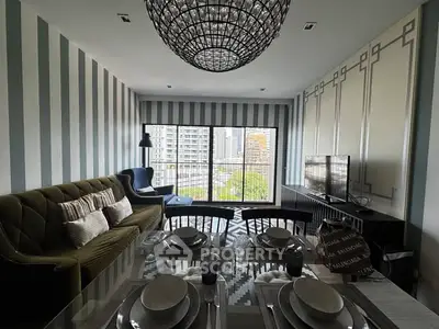 Stylish living room with modern decor and city view, featuring elegant furniture and a large window.