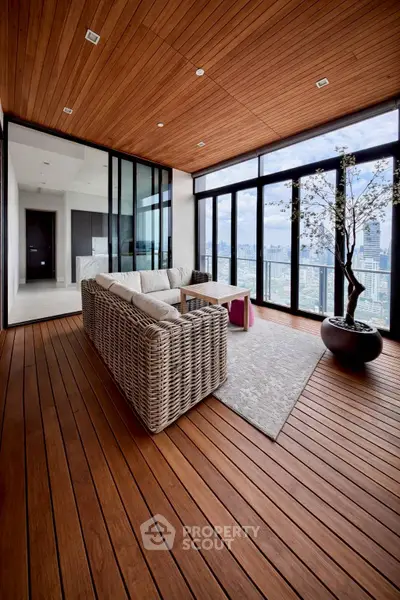 Luxurious high-rise apartment with stunning city view and elegant wooden flooring.