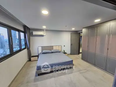 Spacious modern bedroom with city view and ample closet space