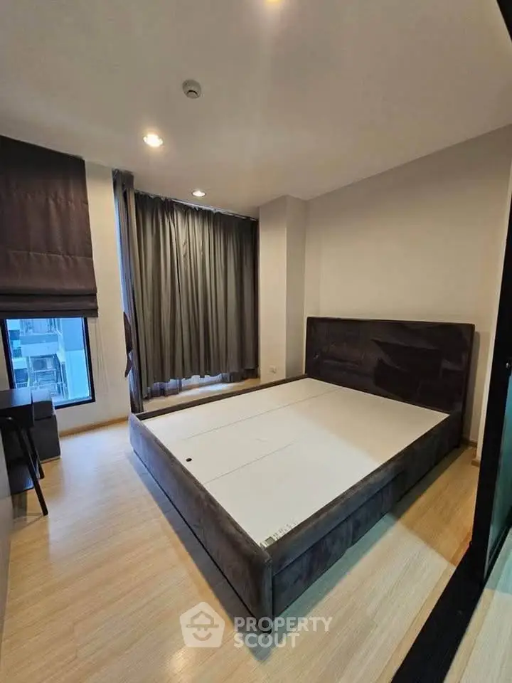 Spacious bedroom with modern design and large windows in a stylish apartment.
