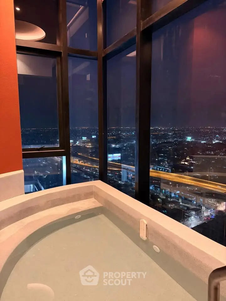 Luxurious high-rise apartment with stunning city view and private indoor pool.