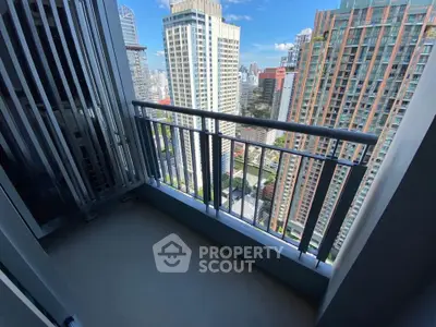 Stunning city view from modern high-rise balcony with sleek railing design.