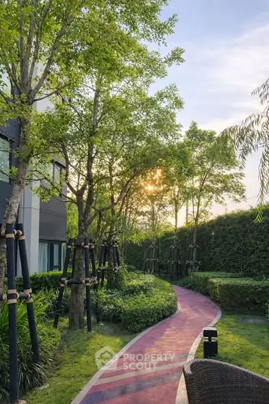 Serene garden pathway with lush greenery and modern building exterior