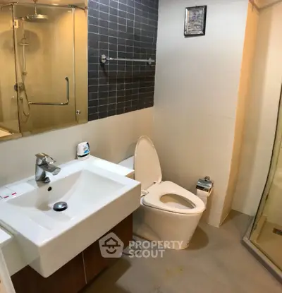 Modern bathroom with sleek fixtures and glass shower enclosure