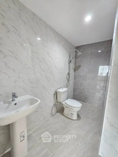 Modern bathroom with marble walls and open shower design