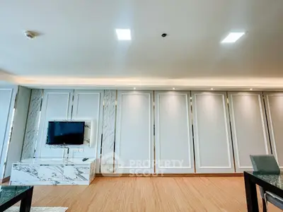 Spacious modern living room with sleek design and built-in TV unit