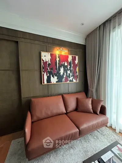 Stylish living room with modern art and leather sofa