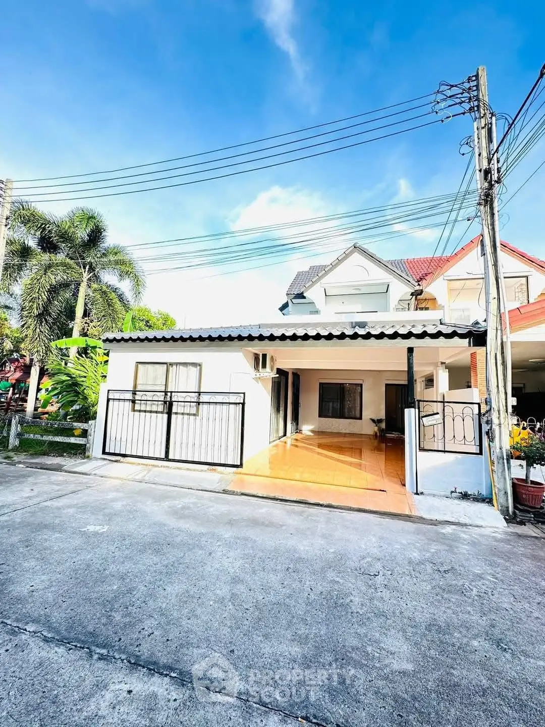 Charming suburban house with spacious driveway and lush greenery
