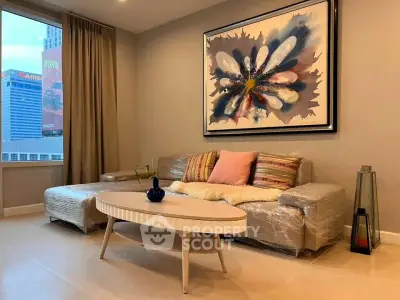 Modern living room with stylish decor and city view, featuring a cozy sofa and contemporary artwork.