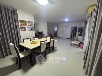 Spacious dining area with elegant table and chairs, perfect for family gatherings in a modern home.