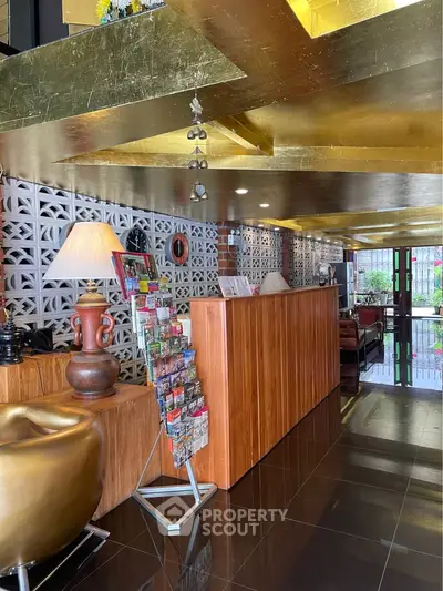 Luxurious hotel lobby with modern decor and stylish wooden reception desk.